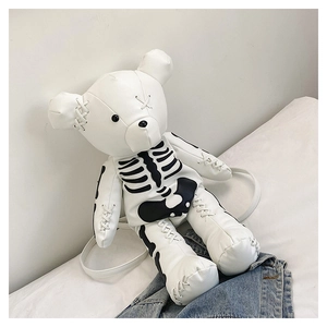 Detail of white bear leather backpack featuring black skeleton print and punk cross stitching