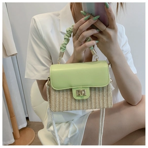 Detail of light green and straw patchwork handbag with rope strap on model