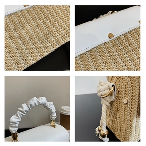 Close-up of woven straw texture and white pleated handle with gold metal accents