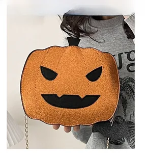 Detail of Halloween pumpkin crossbody bag with sequined chain strap and devil face design