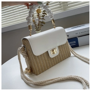 Detail of straw and white leather bag with a pleated handle and rope shoulder strap