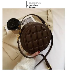 Detailed close-up of dark brown chocolate quilted round crossbody bag with gold hardware