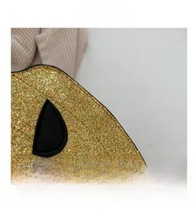 Detailed macro view of golden sequin texture and stitch craft on pumpkin-shaped bag