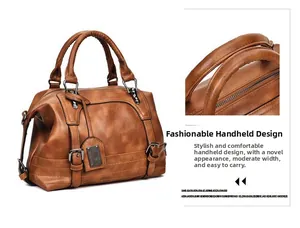 Detail of retro brown leather handbag showing sturdy double handles and metal hardware