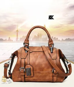 Detail of a brown vintage Boston bag with high-quality leather texture and dual handles