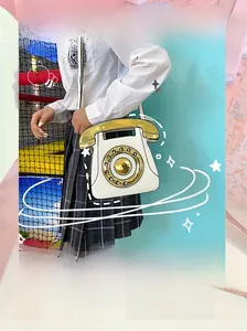 Detail of creative vintage telephone shaped handbag with white PU and golden dial