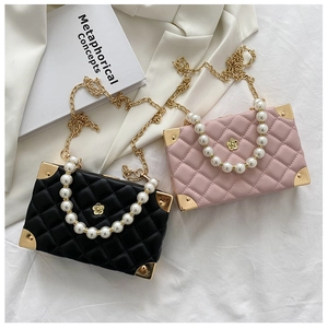 Detail of quilted leather mini bags with pearl handles and gold corner protectors