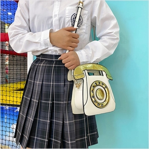 Detail of creative vintage telephone bag featuring a realistic numeric dial and handle