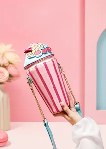 Close-up of a cute ice cream cone shaped crossbody bag with pink stripes and blue details