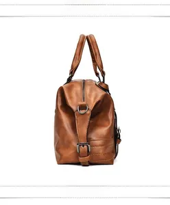 Close-up of brown PU leather bag side with metal buckle and detailed lychee texture
