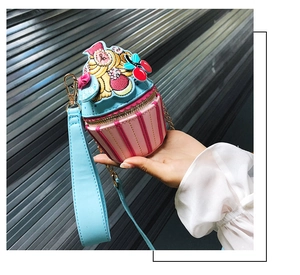 Detail of cupcake shaped crossbody bag featuring colorful embroidery and zip closure