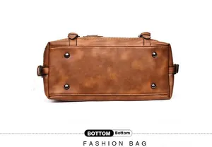 Detail view of the brown vintage Boston bag bottom with four protective metal studs