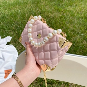 Pink quilted mini box bag with pearl handle, gold chain strap and metal corners