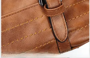 Detailed close-up of brown textured leather with reinforced stitching on Boston bag
