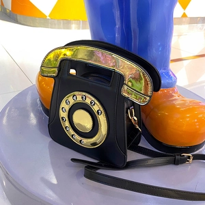 Retro telephone shaped shoulder bag in black matte PU leather with gold laser handle