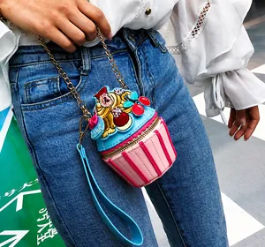 Detailed view of creative cupcake-shaped mini bag with pink stripes and chain strap