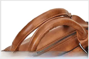 Close-up of comfortable leather handles with precision stitching on a Boston handbag