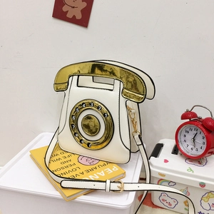 Retro telephone-shaped crossbody bag in white PU leather with golden dial detail
