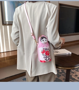 Fashionable pink Russian doll PU leather crossbody bag featuring floral print details