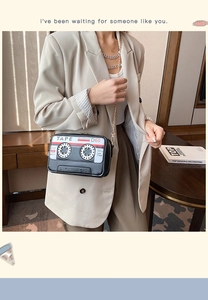 Chic retro cassette tape crossbody bag with gold chain strap shown on a model