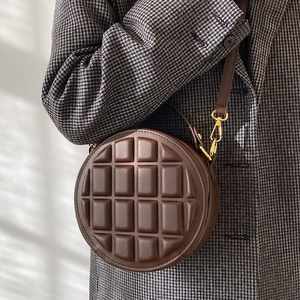 Deep brown quilted round crossbody bag with chocolate grid pattern and gold hardware