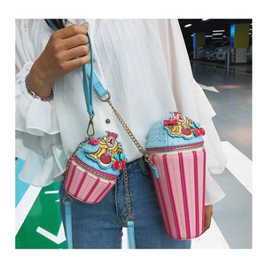 Detail view of pink striped ice cream bucket bags with blue lids and gold chain straps