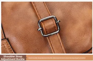 Close-up of adjustable metal buckle on brown lychee pattern leather shoulder strap