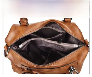 Interior view of brown faux leather Boston bag showing multi-compartment storage space