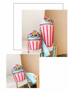 Detail of cupcake shaped crossbody bags with pink stripes, blue lids and pearl accents