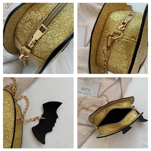 Sparkly gold pumpkin bag with sequin finish, metal chain strap and black bat charm