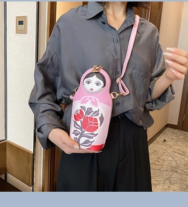 Pink Russian Matryoshka crossbody bag shown on person to display actual size and fit