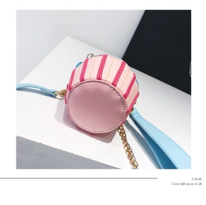 Detail view of the pink and blue cupcake-shaped bag bottom with golden chain strap