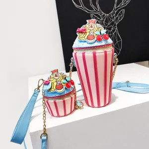 Detail of cupcake shaped crossbody bags with pink stripes and cream topping with cherry
