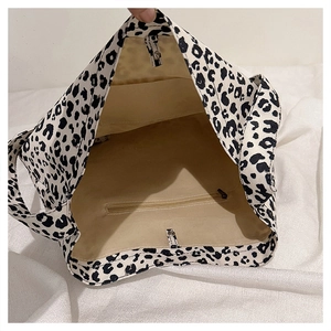 Detailed interior of leopard print canvas tote bag with beige lining and zipper pocket
