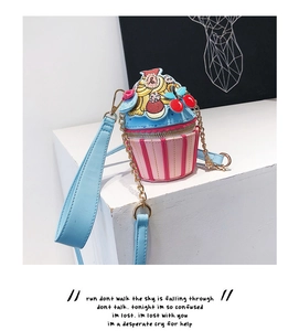 Macro detail of cupcake shaped shoulder bag with pink stripes and floral embroidery