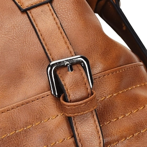Detailed close-up of tan leather texture with yellow stitching and gunmetal buckle
