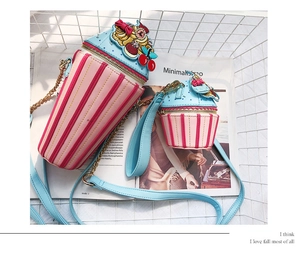 Detail of ice cream themed bucket bag with striped pattern and 3D embroidery accents