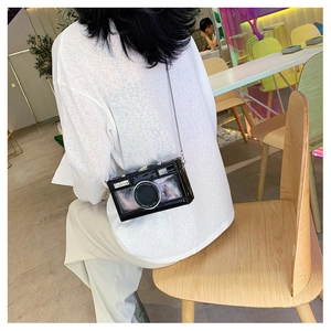 Fashionable black mirrored camera-shaped crossbody bag with a silver chain strap for women