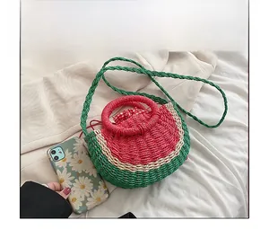 Detail of straw watermelon bag with hand-woven texture and red checkered drawstring liner