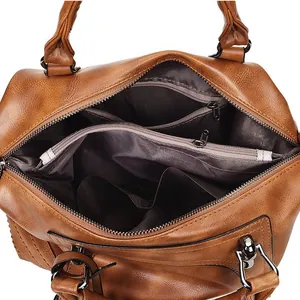 Interior view showing multifunctional compartments and brown fabric lining of Boston bag
