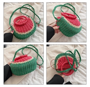 Detail of watermelon straw bag showing woven texture, round handles, and shoulder strap
