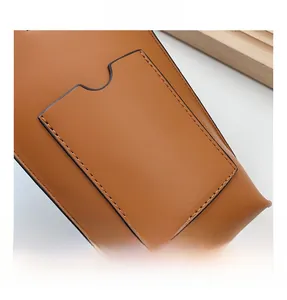 Detail of warm brown leather mobile phone bag featuring a practical external card pocket