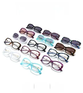 Flat lay of butterfly frame sunglasses in multiple colors with gold metal temple hinges