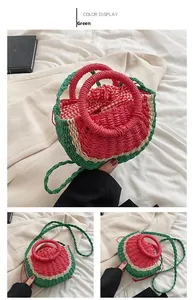 Detail of watermelon-shaped woven straw bag with red plaid drawstring lining and handle