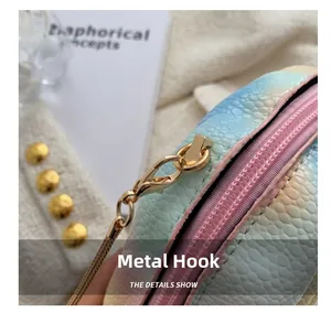Detailed close-up of golden hardware hook and gradient scale texture on small shell bag