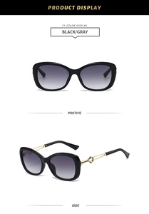Detail of butterfly sunglasses with black frames and gold metal hollowed-out temples