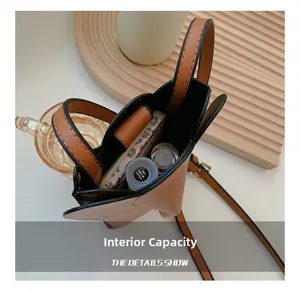Internal capacity of brown leather bucket bag showing space for lipstick and makeup