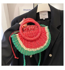 Detail of watermelon-shaped straw handbag with woven textures and red checkered inner lining