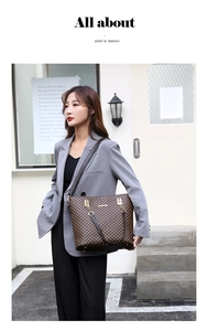 Classic checkered tote bag detail with leather handles and gold metal hardware