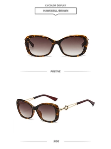 Detail view of tortoiseshell butterfly sunglasses with brown gradient lenses and gold temples